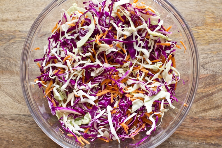 Coleslaw ingredients in a glass bowl