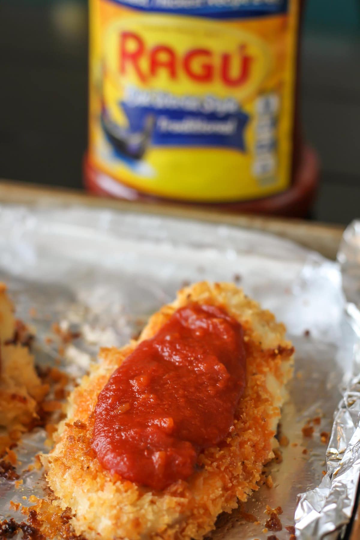 Baked Chicken Parmesan topped with Ragú sauce