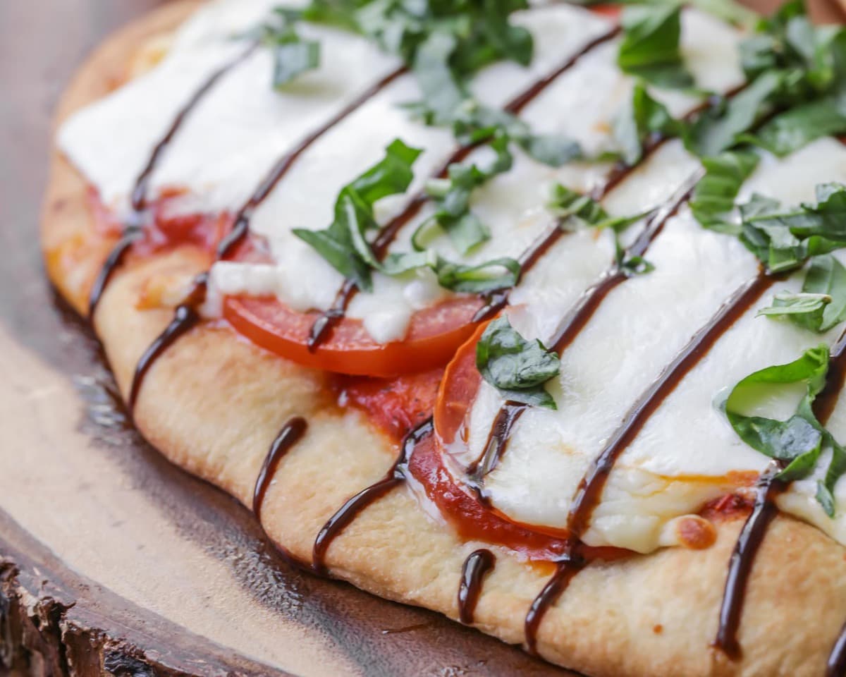 Quick dinner ideas - caprese pizza drizzled with balsamic glaze.