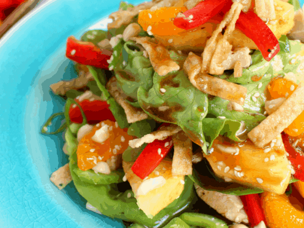 Loaded with sweet, tropical flavors, this delicious Luau Salad is BETTER than what you'll get at Cheesecake Factory! Fresh pineapple, mandarin oranges, celery, onions, wantons and a sweet pineapple balsamic dressing top this easy-to-make layered salad. Perfect for summer on the patio!