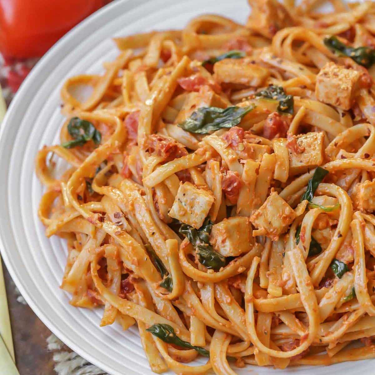 Sun Dried Tomato Pasta with chicken and spinach on a plate