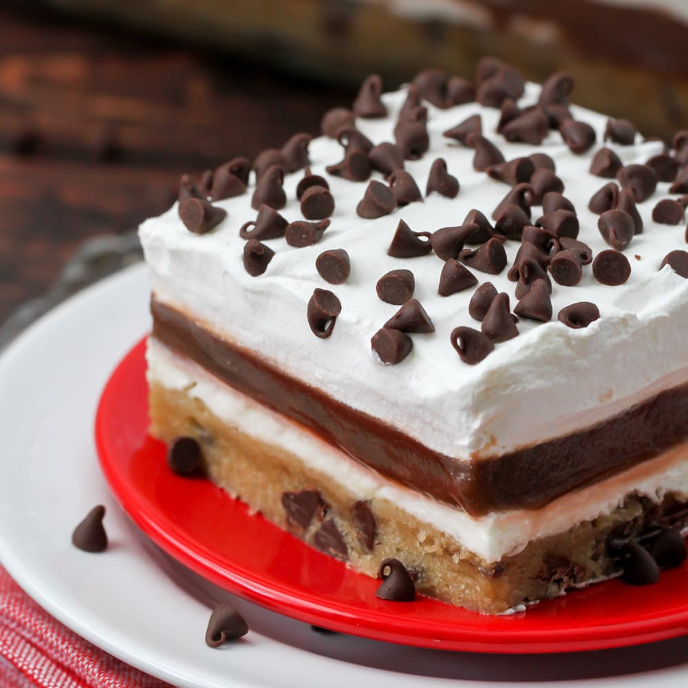 Valentine's Day Desserts - chocolate chip cookie delight topped with mini chocolate chips on a red plate. 