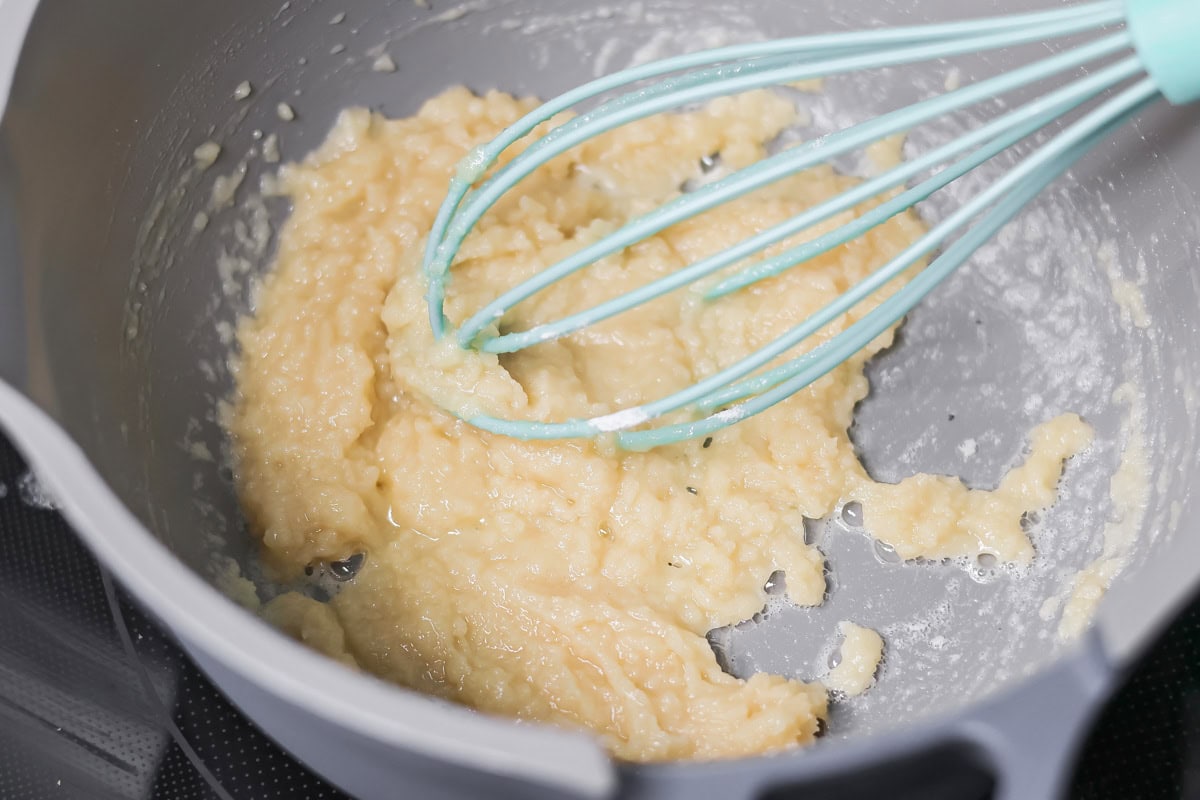 Whisking roux to make ham and potato soup.