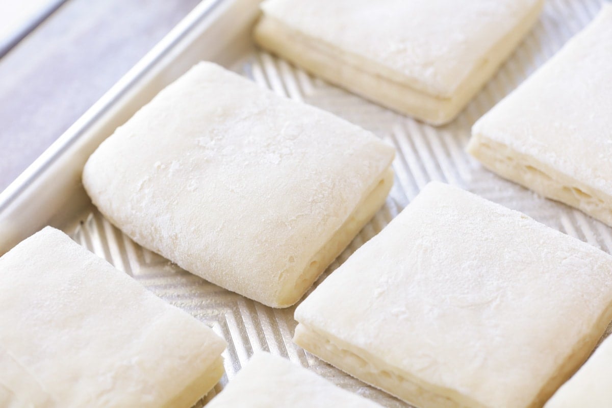 dough cut into squares on a cookie sheet