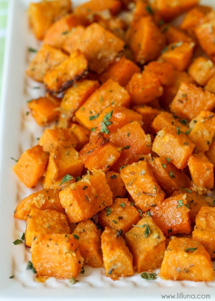 Vegetable side dishes - a pile of baked sweet potato cubes topped with fresh herbs.