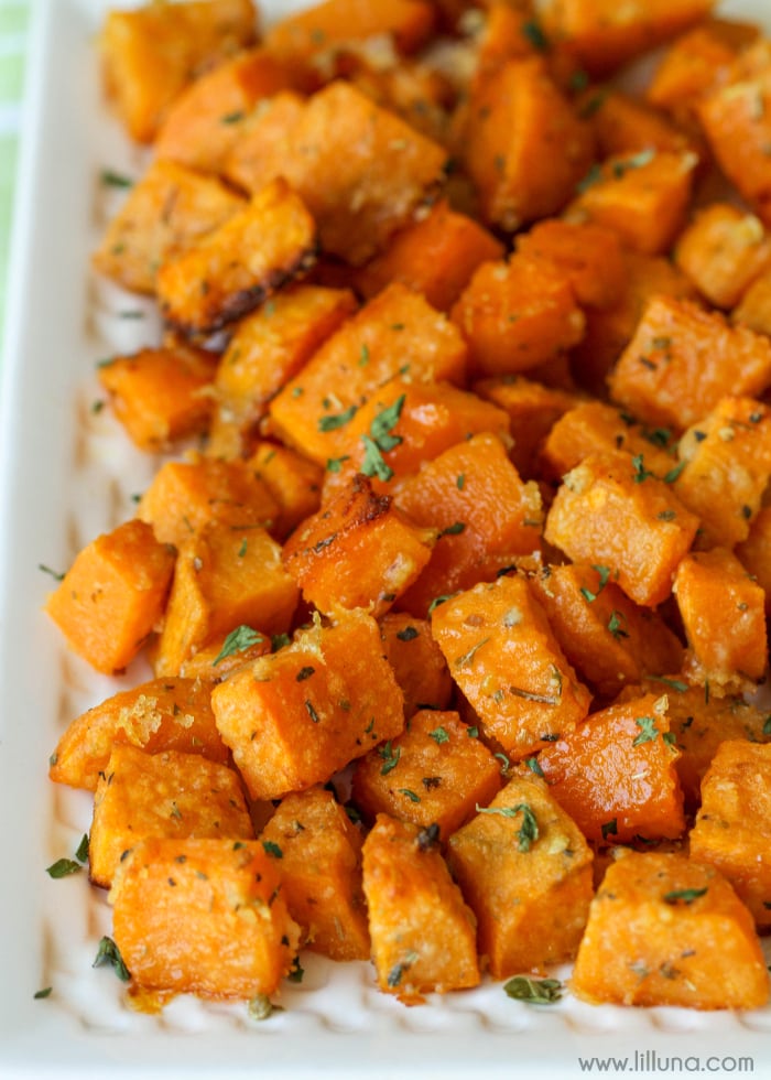 Easy side dishes - baked sweet potato cubes piled on a white plate.