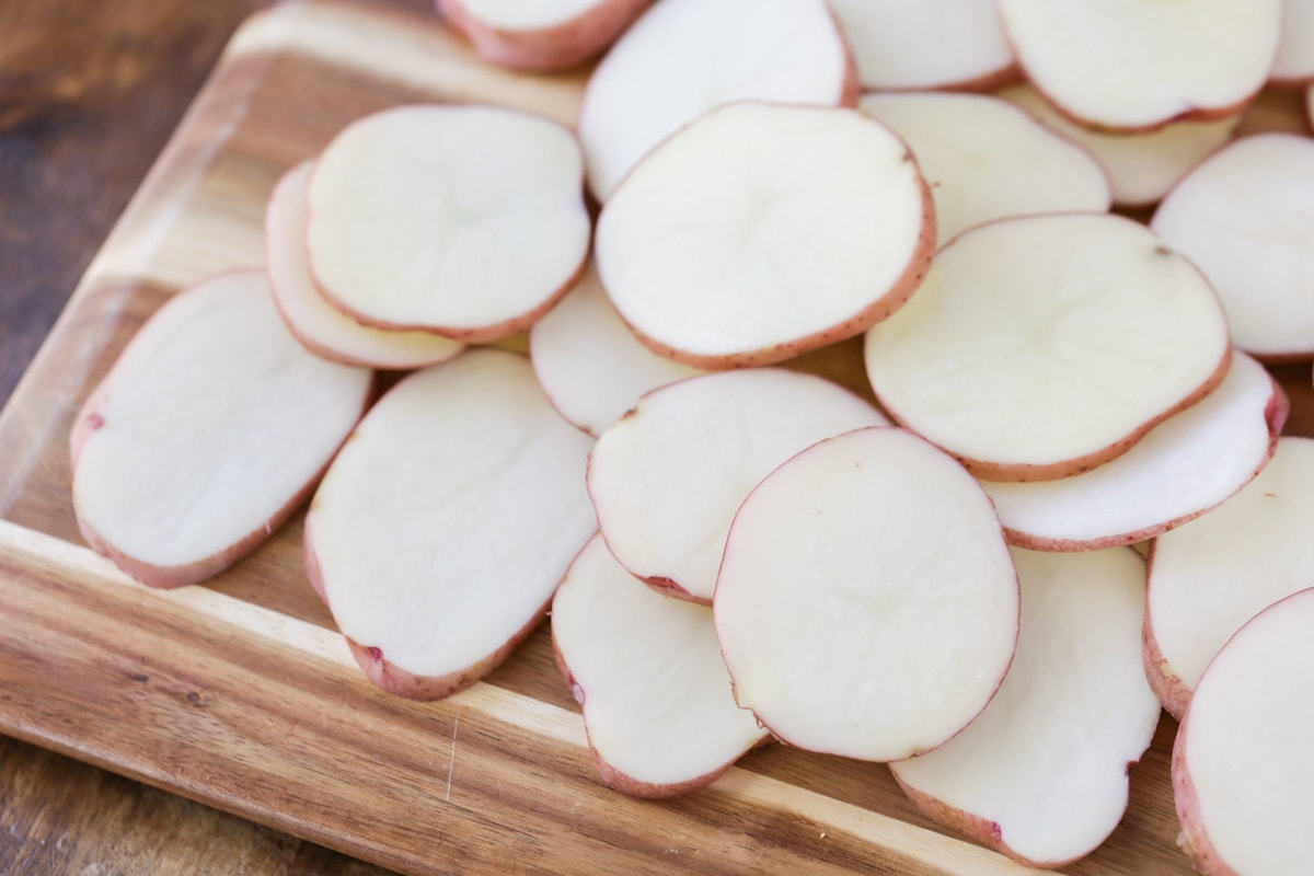 Sliced red potatoes on cutting board