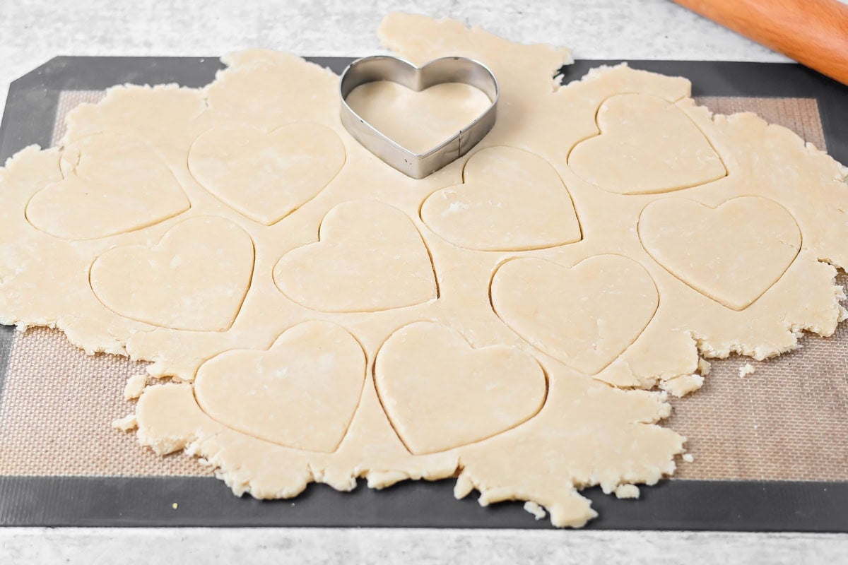 Dough rolled out on Silpat with cut out hearts.