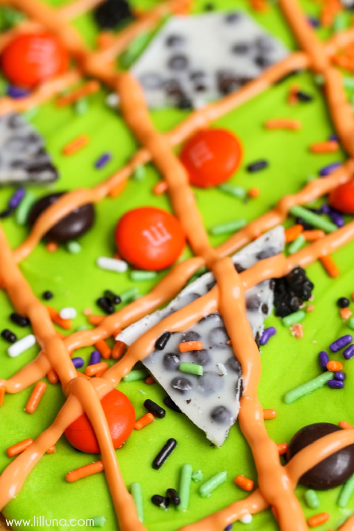 Close up of green frosting topped with candy.