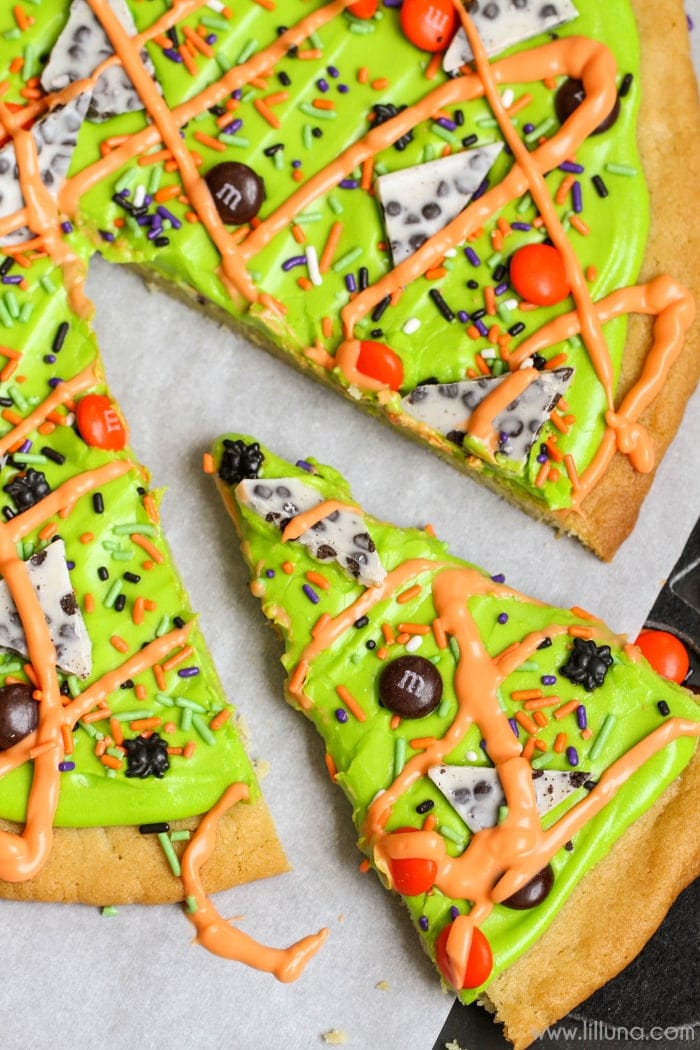 A slice of halloween cookie cake on wax paper.