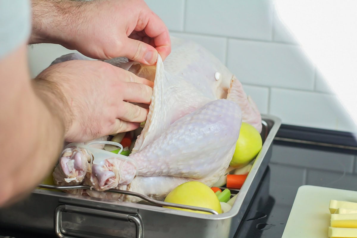 Stuffing butter under the skin of the turkey.