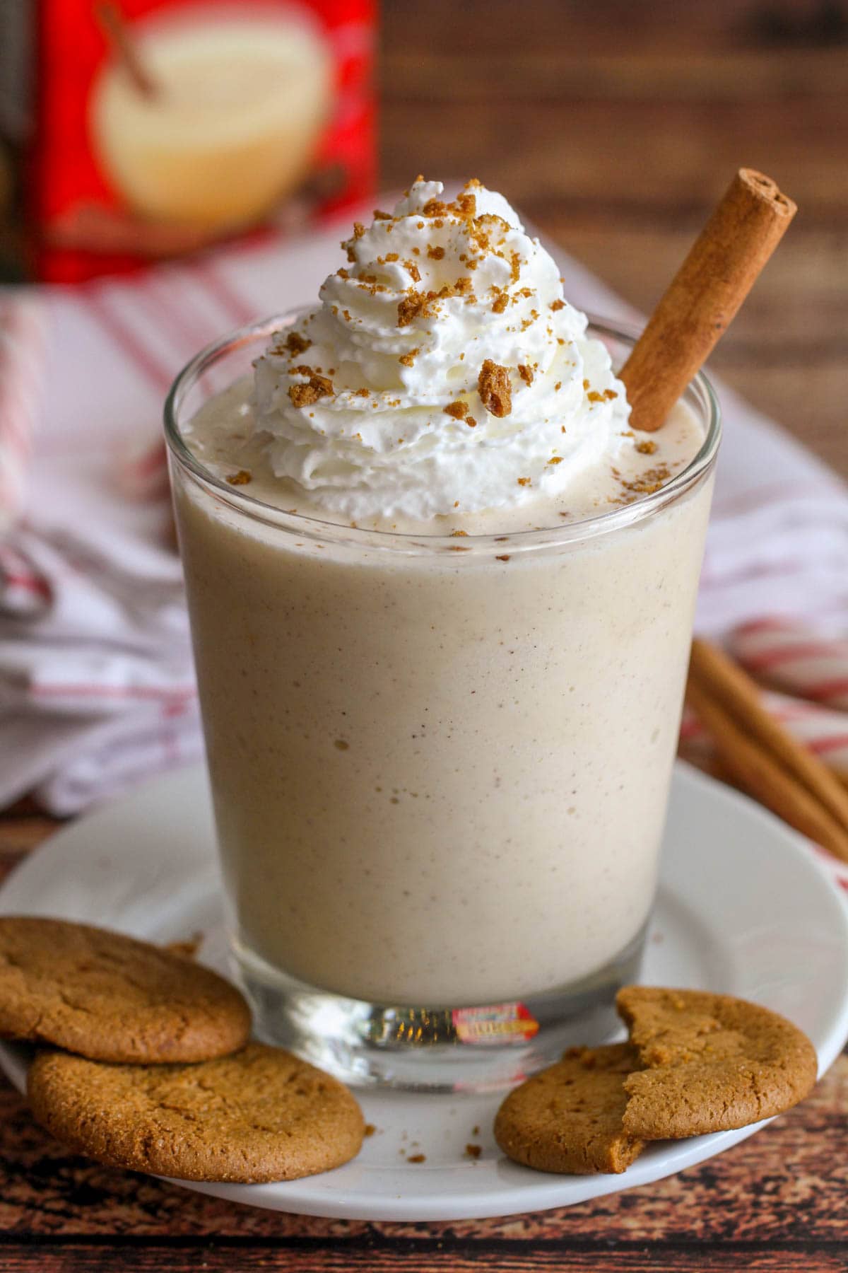Eggnog milkshake recipe served on a white plate with gingersnaps.