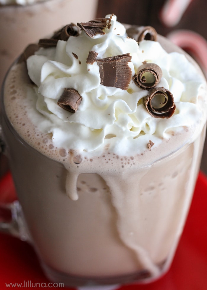 3-Ingredient Frozen Hot Chocolate - this drink takes a minute to make and is SO delicious!! All you need is some milk, hot cocoa packets, and ice and of course some cool whip and chocolate curls for topping!