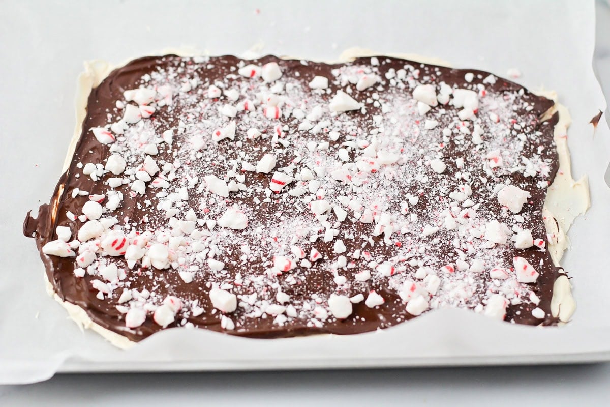 Peppermint bark on parchment paper for cheesecake recipe.