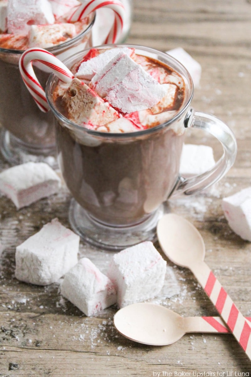 Homemade Peppermint Swirl Marshmallow served in hot chocolate with a candy cane