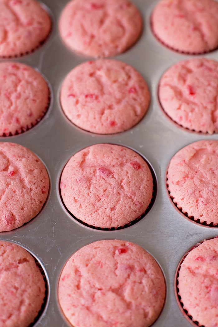 Cherry cupcakes in a baking pan.