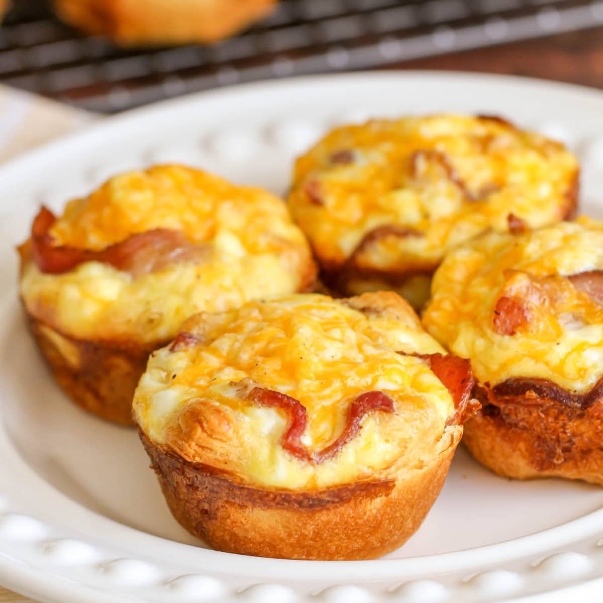 Thanksgiving breakfast ideas - several breakfast egg cups served on a white plate.