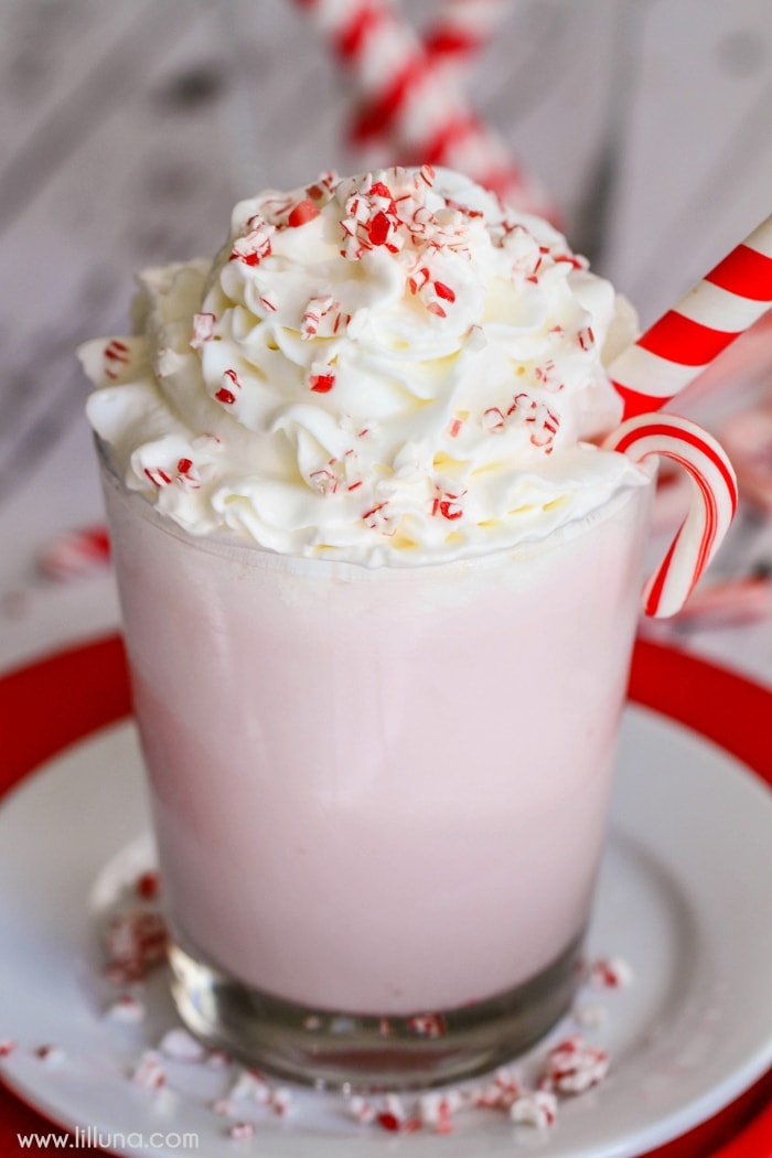 Close up of a peppermint milkshake topped with candy cane bits.