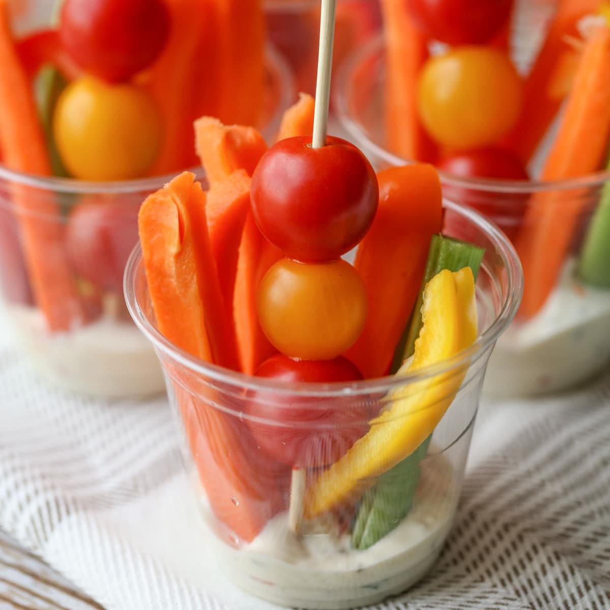 Clear cups with veggie appetizers and dip 