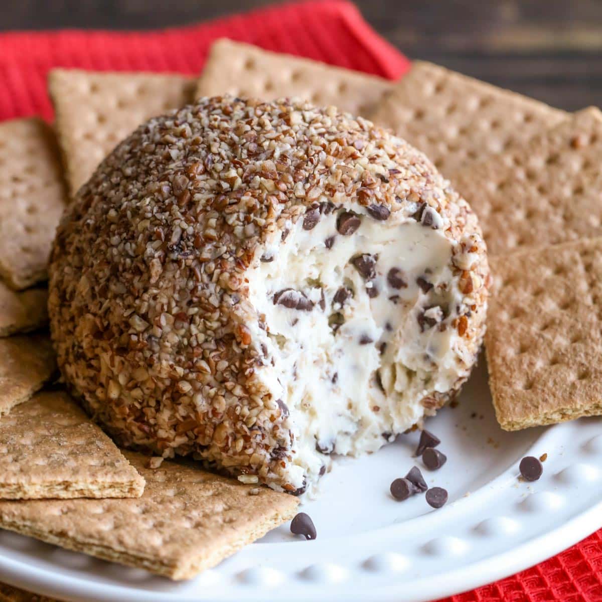 Chocolate chip cheese ball served with graham crackers on a white plate