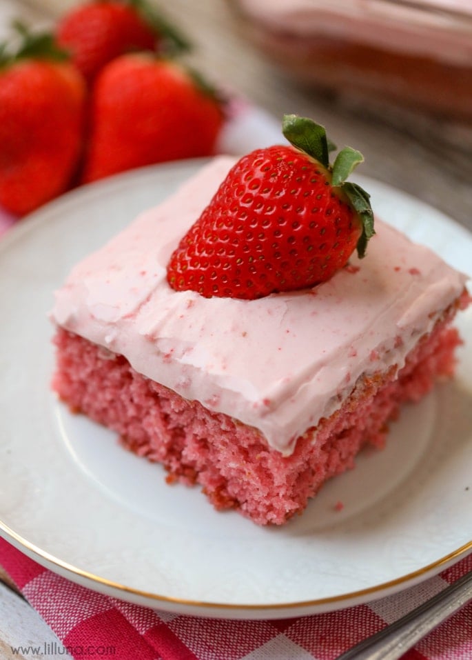 Holiday cakes - strawberry sheet cake slice with fresh strawberry on top.
