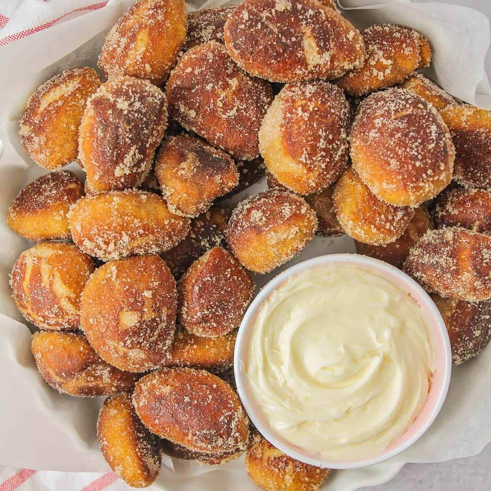 Bite sized cinnamon sugar pretzels with a side of cheesecake dip