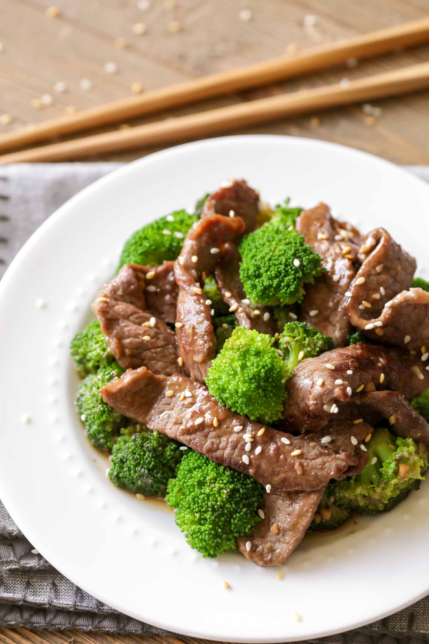 Beef and Broccoli recipe with sesame seeds on white plate