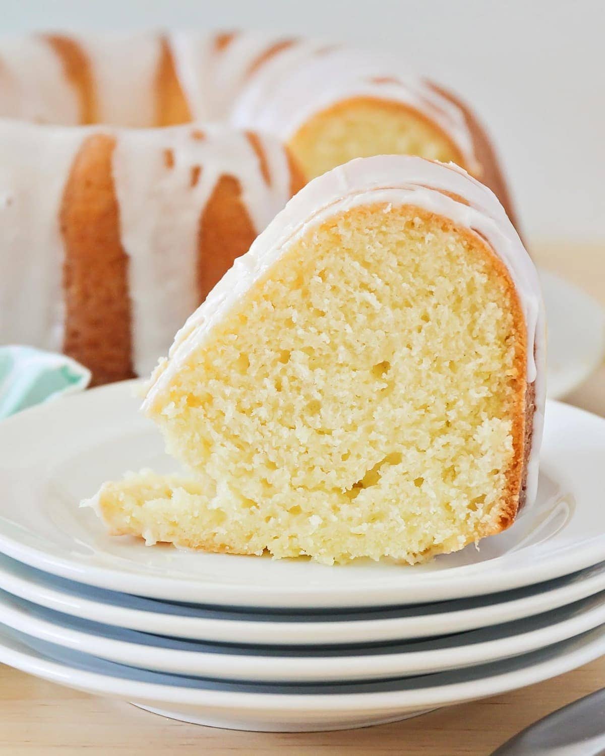 A slice of lemon pound cake with lemon glaze on top.