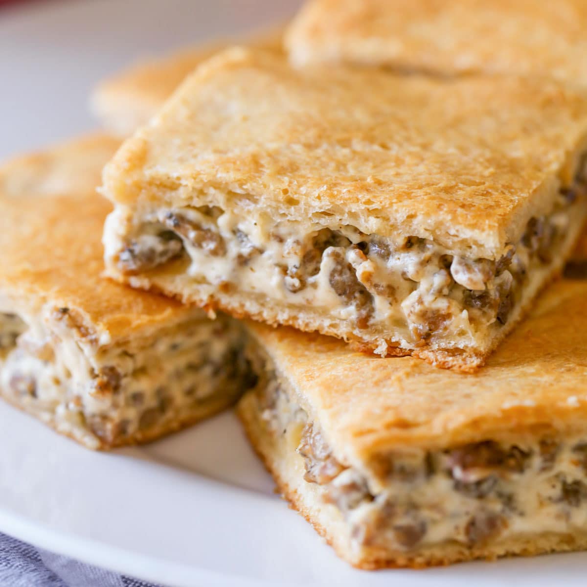 Sausage cream cheese casserole sliced and served on a white platter.