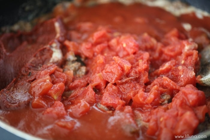 tomatoes and sauce cooking in a skillet