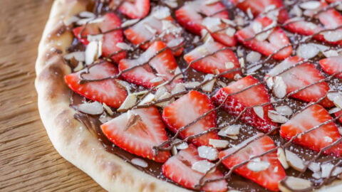 Homemade strawberry nutella pizza on counter.