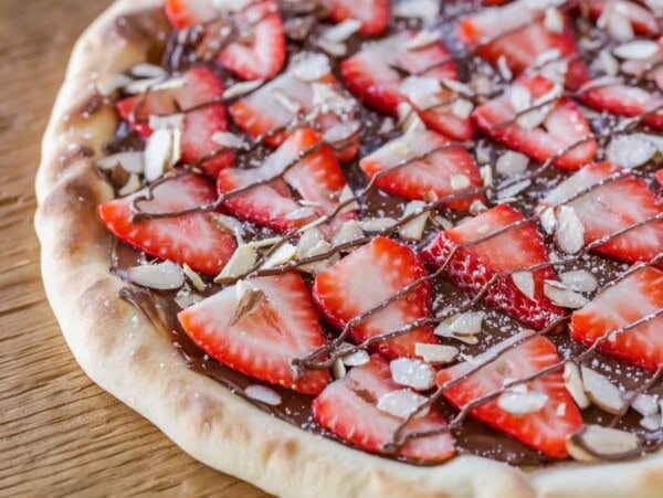 Homemade strawberry nutella pizza on counter.