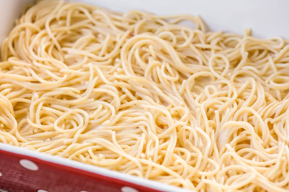 Cooked spaghetti noodles in baking dish