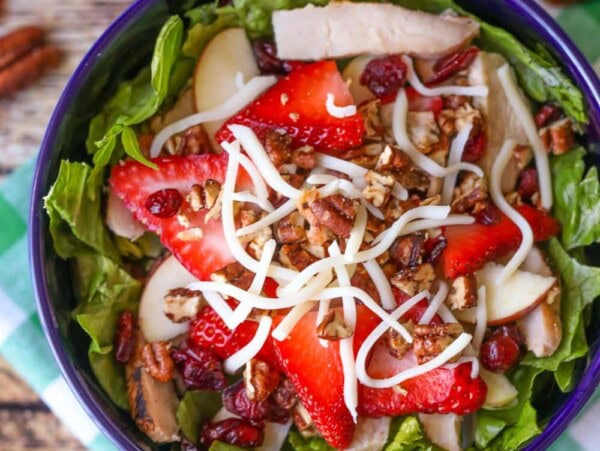Strawberry harvest salad served in a blue bowl.