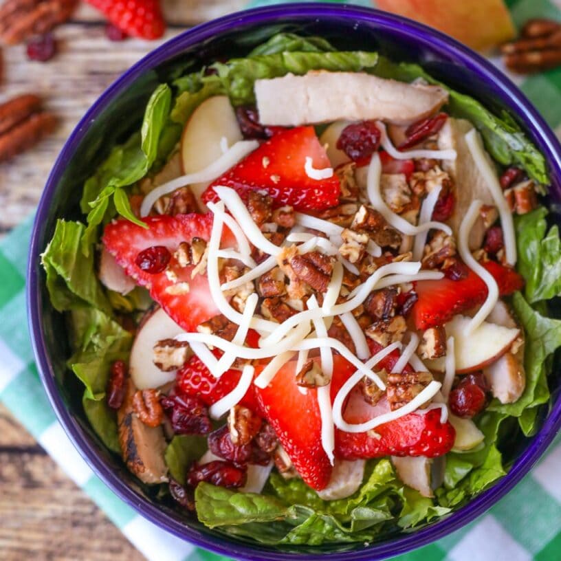 Strawberry harvest salad served in a blue bowl.