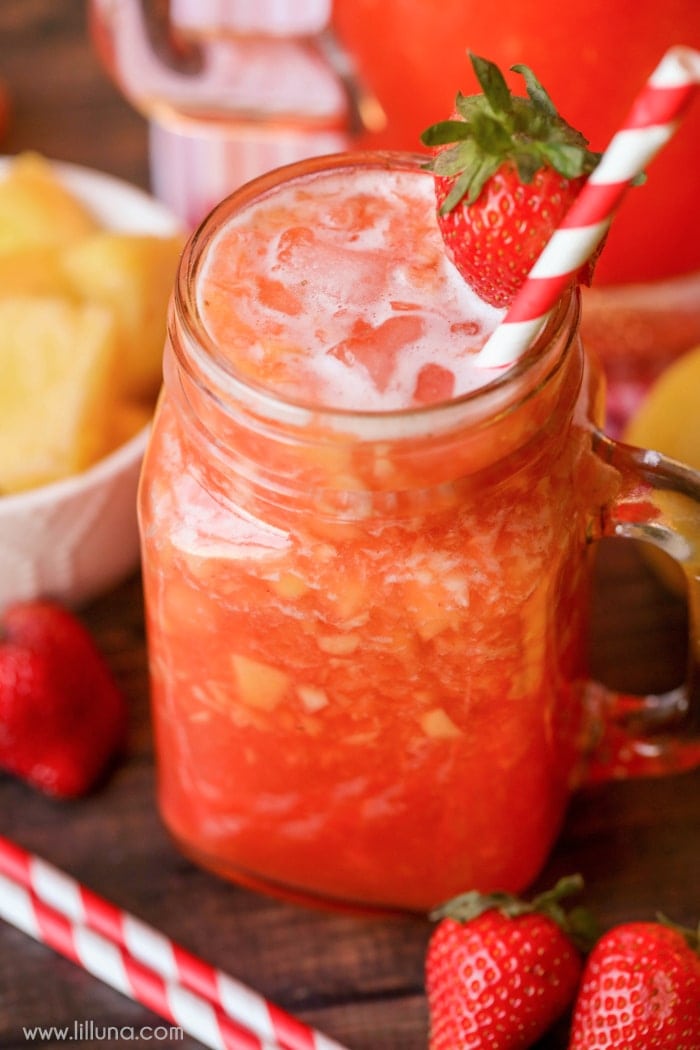 The BEST Strawberry Lemonade in a glass mug with a fresh strawberry