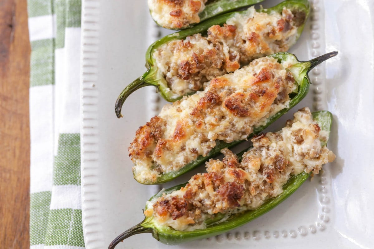 Healthy Appetizers - sausage stuffed jalapenos on a white plate. 