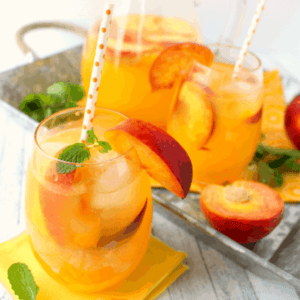 The perfect cold drink for sipping on a hot summer day! This delicious Sparkling Peach Lemonade is made with just a few simple ingredients and comes together in just minutes. Fantastic for picnics, parties and showers, too!