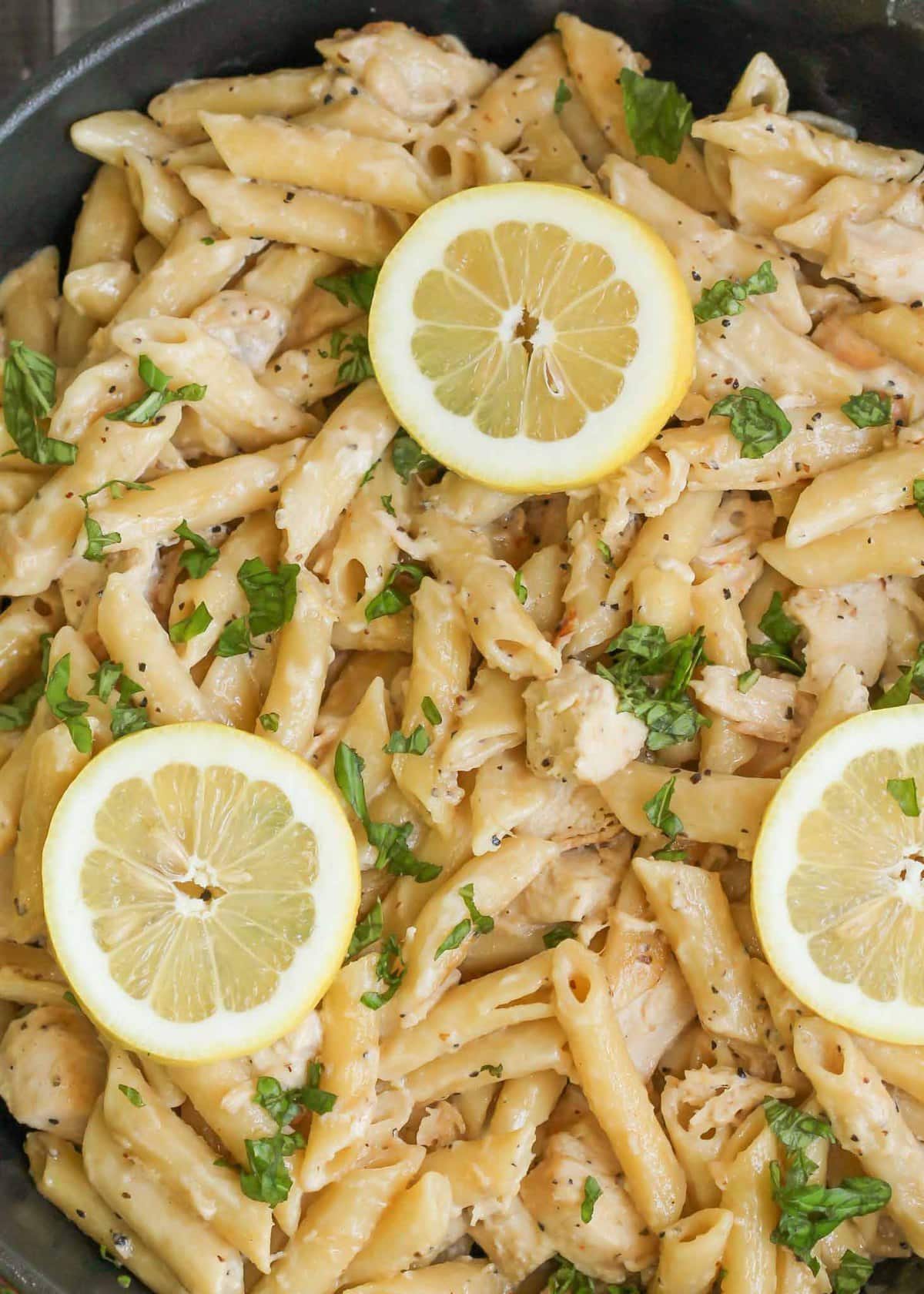 Creamy Lemon Chicken topped with parsley and lemon slices.