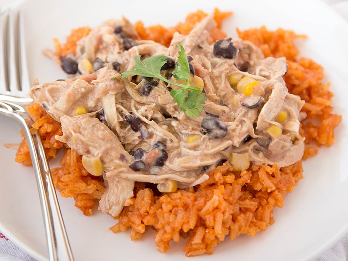 creamy fiesta chicken over mexican rice, topped with cilantro