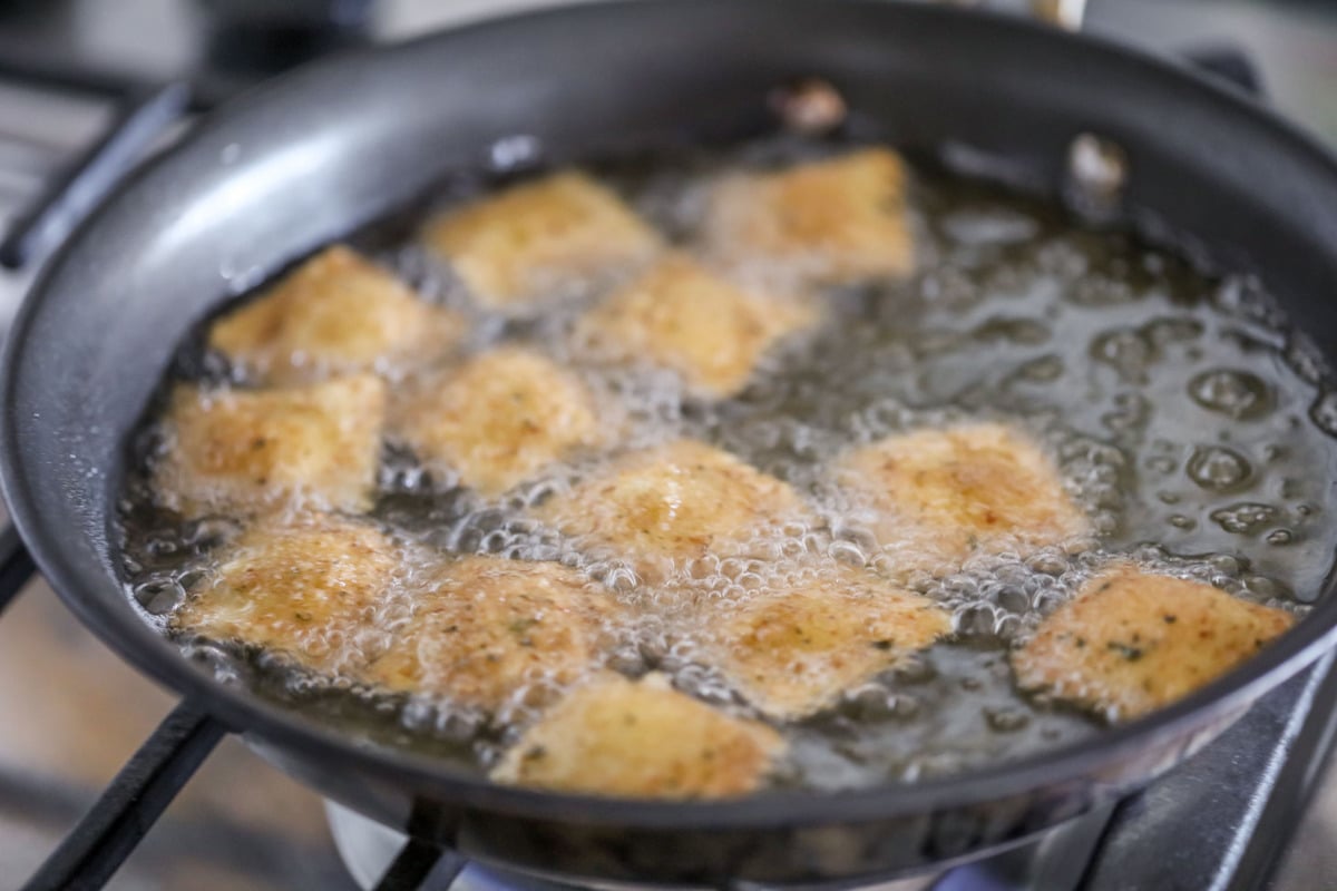 Cooking Fried Ravioli in a pan of oil.