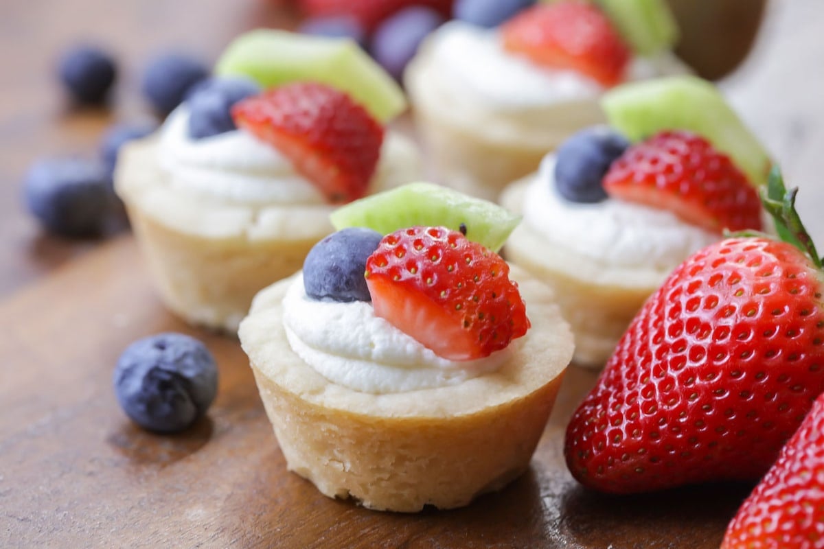 Thanksgiving desserts - mini fruit tarts topped with fresh fruit.