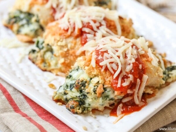 Baked stuffed chicken parmesan on a white plate.