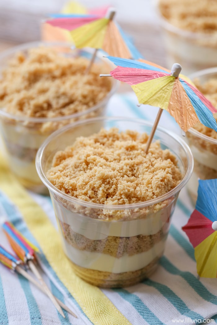 Sand Pudding cups on a colorful towel topped with beach umbrellas