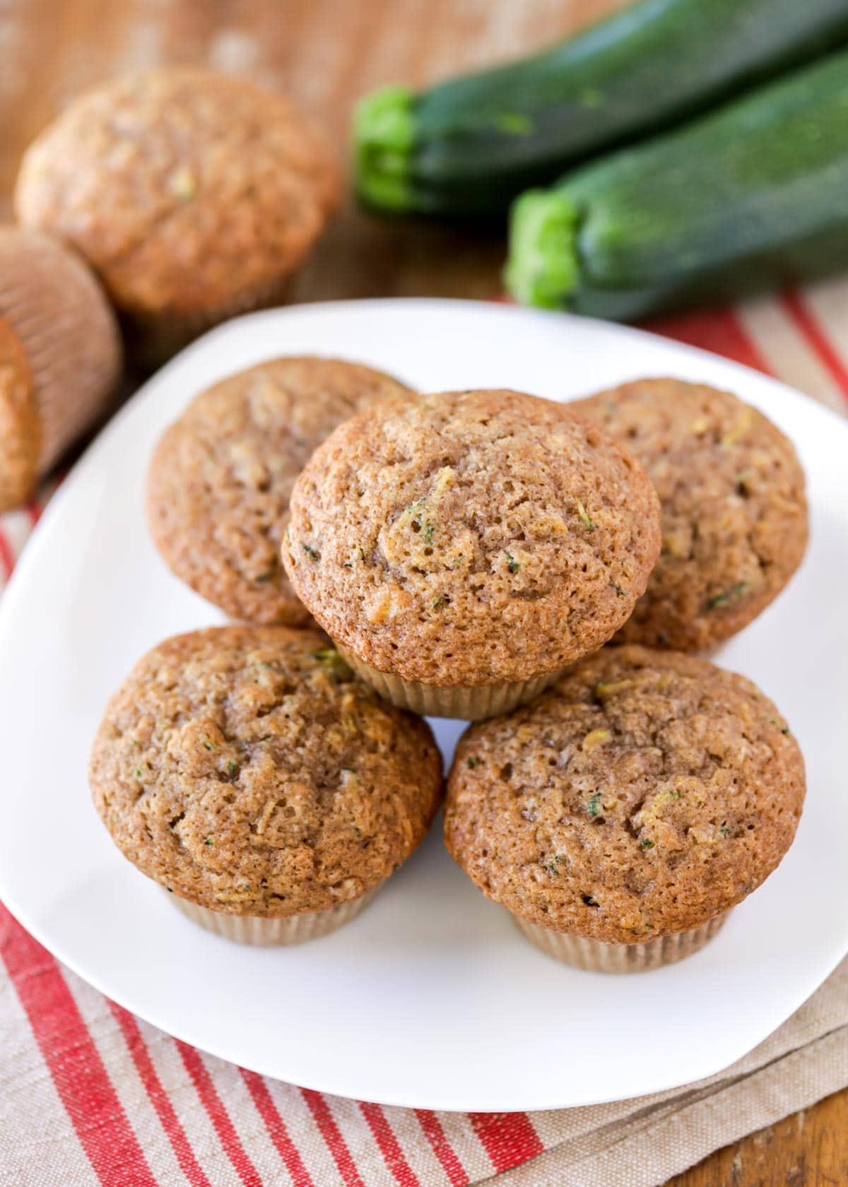 Easy zucchini muffins stacked on white plate