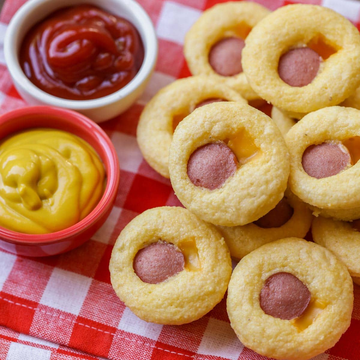 Finger food appetizers - corn dog muffins served with ketchup and mustard.
