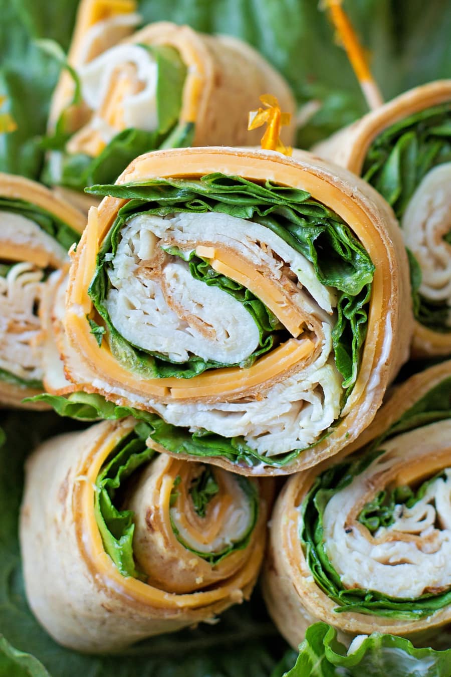 Chicken, Cheddar and Lettuce Flatbread Pinwheels rolled and stacked