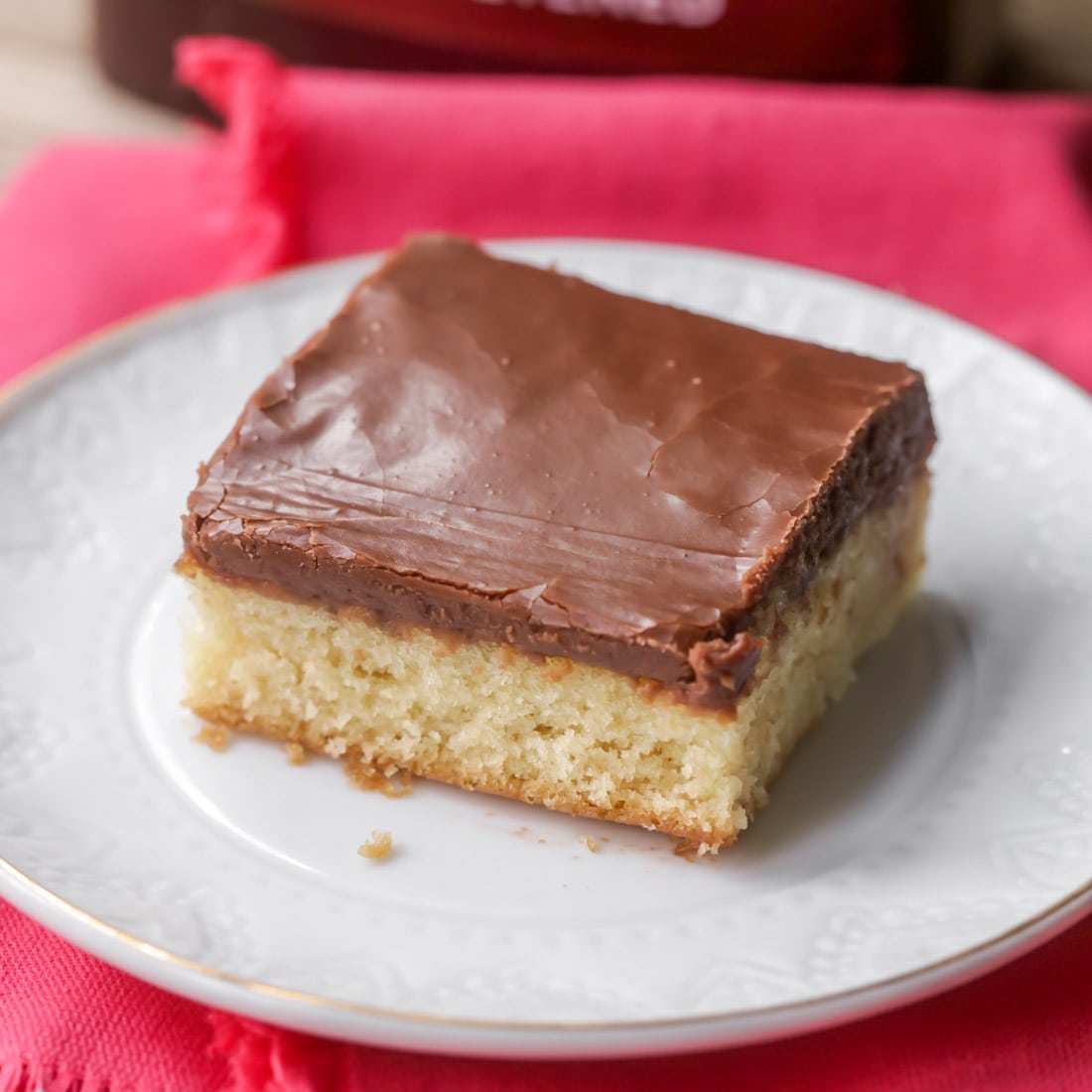 White sheet cake with chocolate frosting on a plate