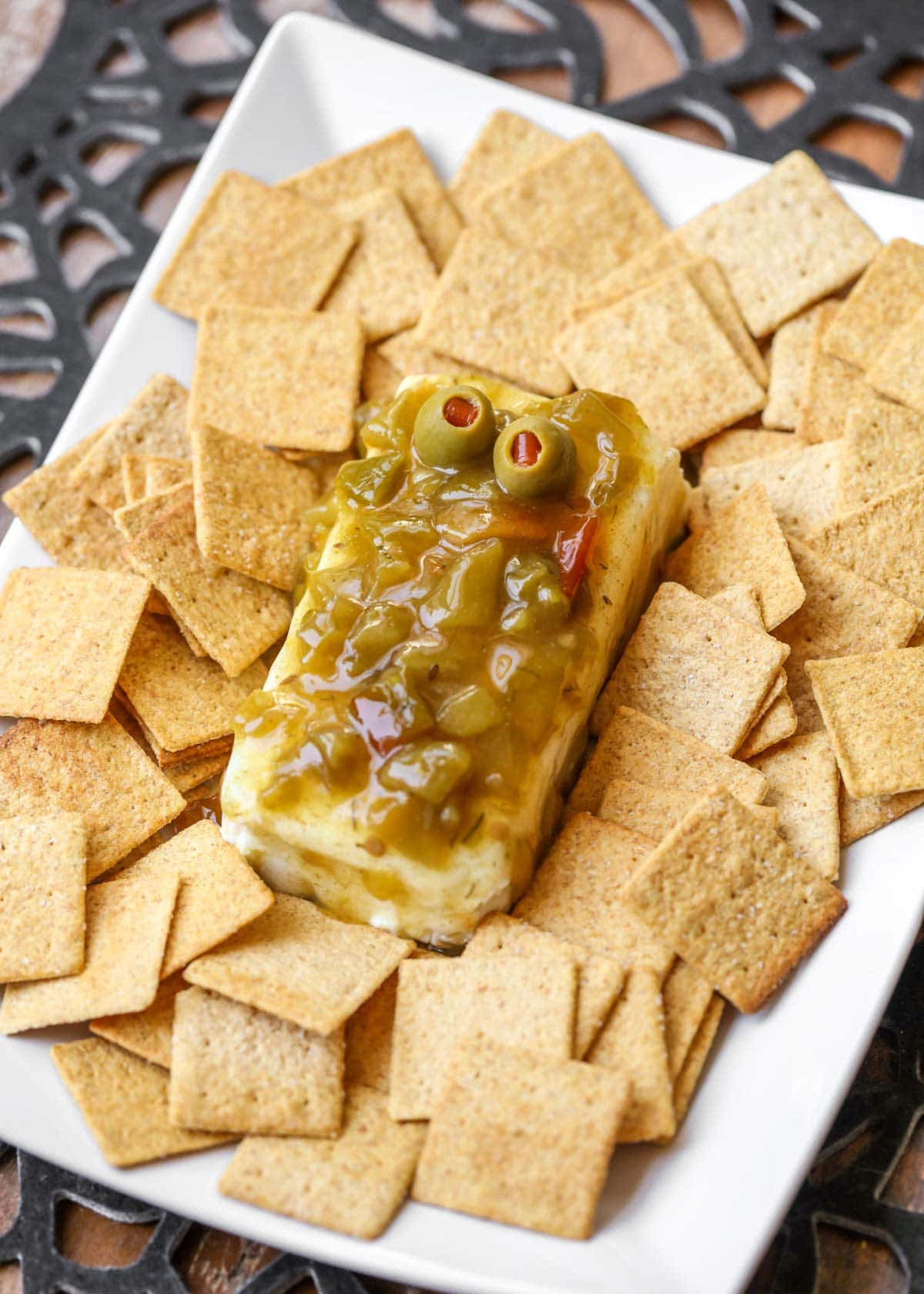 Green chili cream cheese dip with green olives for eyes