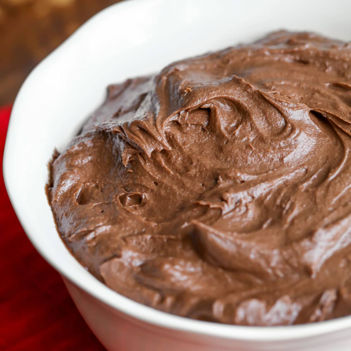 Chocolate frosting in a white bowl